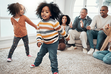 Image showing Big family, children dancing and living room with parents, grandparents or love with applause in home. Kids, men and women with dance, smile or happiness for brother, sister and together on holiday