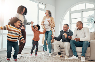 Image showing Big family, children dancing and living room with parents, grandparents or love with holding hands in home. Girl kids, mom and dad with cheerful dance, smile or happiness in house together on holiday