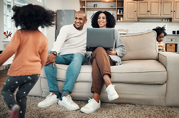 Image showing Parents, relax and children playing in a home or house with mom and dad working on laptop and spending quality time together. Happy, playful and young couple or mother and father watching kids play