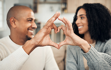 Image showing Love, happy and hand heart by couple on sofa with love, care and trust at home together. Emoji, shape and man with woman hands in support of hope, marriage and unity, smile and joy in living room