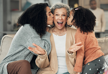 Image showing Portrait, kiss and grandmother with girl and woman on a sofa, smile and happy at family home together. Kissing, face and excited senior with adult daughter and grandchild on couch, bond and joy