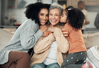 Image showing Kiss, portrait and grandmother with girl and woman on a sofa, hug and happy in their home together. Kissing, face and excited senior woman with adult daughter and grandchild on couch, bond and smile