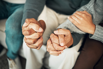 Image showing Support, love and family holding hands on sofa for comforting embrace, prayer and trust together at home. Motivation, empathy and connected parents and adult children for care, compassion and praying