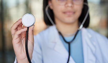 Image showing Healthcare, stethoscope and hands of doctor listen in clinic for wellness, medical care and check up. Hospital, cardiology mockup and woman worker with tools for heart disease, exam and consulting