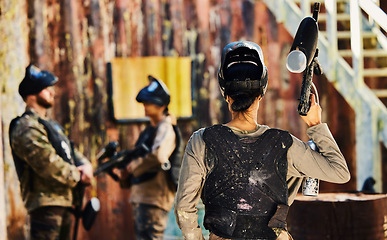 Image showing Paintball, back view or woman with gun in game or competition for fitness, exercise or cardio workout. War soldier, challenge or female warrior with army weapon or marker for military target training