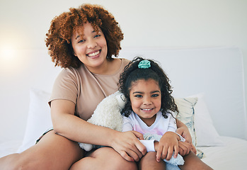 Image showing Mother, home and young girl portrait on a bed in the morning with toy in a family bedroom. House, smile and happy mom with a child with mama love and care for her kid with happiness while relaxing