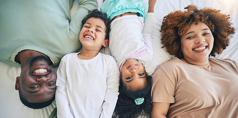 Image showing Portrait, top view and parents with children in bed enjoy morning for bonding, quality time and relaxing. Black family, home and happy mother, father and kids in bedroom for affection, trust and love