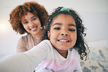 Image showing Mother, bedroom and young girl selfie on a bed in the morning in a family home. House, smile portrait and happy mom with a child taking a picture for social media with mama love and care for her kid