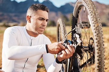 Image showing Cycling, fixing and wheel with man in nature for sports, wellness and fitness training. Insurance, safety and tire change with cyclist and repair mountain bike on trail for broken, puncture and check