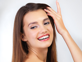 Image showing Makeup, hair and face of woman with smile on white background for wellness, skincare and beauty treatment. Salon aesthetic, dermatology and happy girl for cosmetics, haircare and luxury in studio