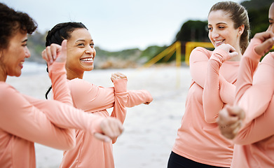 Image showing Women, volleyball and team stretching on beach excited to play match, competition and sports games. Teamwork, fitness and happy female players stretch arms for warm up, training and exercise on sand