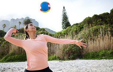 Image showing Volleyball, beach and spike with a sports woman playing a game outdoor in nature alone for recreation. Fitness, exercise and training with a female athlete hitting a ball during a match on the coast