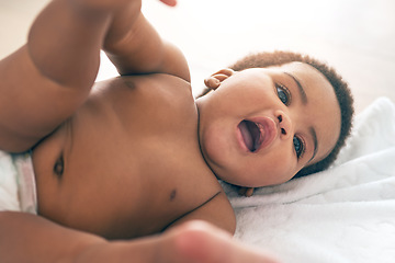 Image showing Kids, black baby and a girl lying on a towel in her home for growth or child development from above. Children, bedroom and cute with a newborn infant female resting on a bed to relax in a house