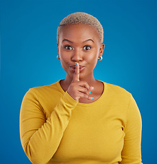 Image showing Shush, secret and portrait of black woman in studio for secret, announcement and news. Silence, mystery and privacy with female isolated on blue background for rumor, gossip and confidential