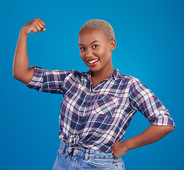 Image showing Muscle, arm flex and portrait of black woman in studio for empowerment, confident and success. Achievement, hard work and pride with female isolated on blue background for power, strong or motivation