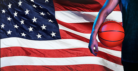 Image showing Sports, usa flag, and basketball with hand of man for fitness, training and competition match. Championship, games and muscle with athlete and ball with American pride for national, league and club