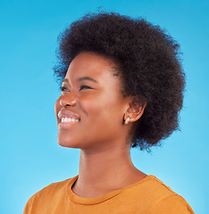 Image showing Thinking, smile and happy black woman wondering looking away in thought isolated against a blue studio background. Afro, casual and face of young African American female relax, calm and confident