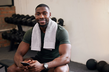 Image showing Gym, phone and portrait of happy man rest to check social media, search internet and workout progress app. Black male, sports break and mobile technology for fitness, smile and bodybuilder training