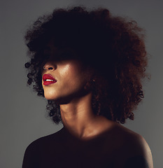 Image showing Beauty, shadow and black woman haircare and makeup as skincare, cosmetic and self care in the dark or night. Spotlight, creative and face of female model with mystery aesthetic and luxury fashion