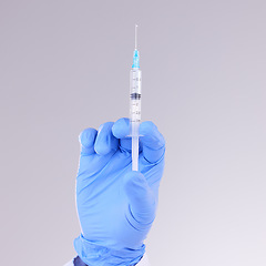 Image showing Hands, vaccine and healthcare with a doctor in studio on a gray background holding monkeypox treatment. Medical, innovation and insurance with a medicine professional ready to administer a cure