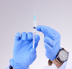 Image showing Hands, vaccine and healthcare with a doctor in studio on a gray background holding monkeypox treatment. Medical, innovation and insurance with a medicine professional ready to administer a cure