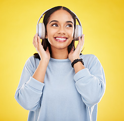 Image showing Happy, music and headphones with woman in studio for streaming, online radio and audio. Smile, media and podcast with female isolated on yellow background for technology, listening and connection