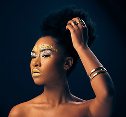 Image showing Beauty, gold and glitter with black woman and makeup in studio for luxury, cosmetics or African pride. Natural, creative and goddess with female model on black background for queen, bronze or glamour