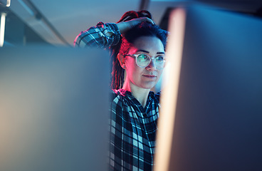 Image showing Cybersecurity, malware and woman hacker working on a computer in the basement at night for phishing. Database, password and ransomware with a female coder hacking a digital transformation network