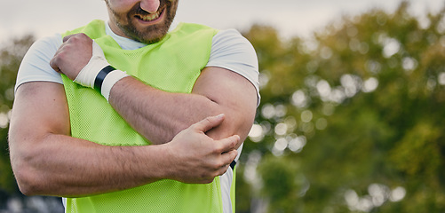 Image showing Rugby, pain and man with arm injury on sports field after practice match, training and game outdoors. Medical emergency, accident and male athlete with joint inflammation, elbow sprain and tendinitis