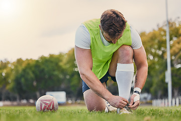 Image showing Sports, soccer and man tie shoelace, training and workout for balance, wellness and healthy lifestyle. Male player, guy or athlete tying shoe, fitness and practice for match, exercise and performance