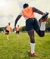 Image showing Sports, men training and outdoor rugby on a grass field with a team stretching legs as warm up. Athlete group together for fitness, exercise and workout for professional sport with coach and teamwork