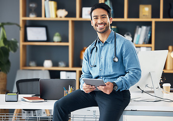 Image showing Relax, tablet and portrait of doctor sitting on table or desk in medical office holding device for internet, web or online use. Man healthcare professional satisfied with health app or connection