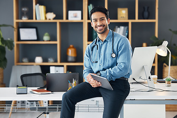 Image showing Relax, tablet and portrait of healthcare professional holding device for internet, web and online connection in a office. Medical, smile and happy man doctor sitting on table or desk is satisfied