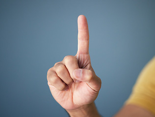 Image showing Man, hand and pointing up in studio with mockup for question, choice or vote on blue background. Product placement, finger showing deal announcement or information with mock up space for notification