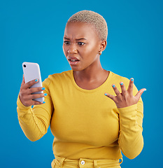 Image showing Phone, wtf and confused black woman in studio for fake news, social media and text on blue background. Omg, scam and girl with smartphone notification for phishing alert, glitch or internet problem