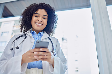 Image showing Phone, healthcare and woman doctor with mobile app, network or telehealth service for hospital management. Medical professional or biracial person typing on cellphone or smartphone in clinic below