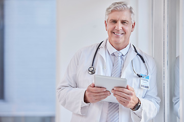 Image showing Portrait, man and doctor with tablet, healthcare and career with success, connection and research in hospital. Face, mature male and medical professional with technology, online reading and diagnosis