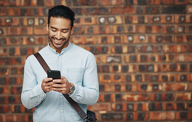 Image showing Employee, startup and man with smartphone, wall and connection with happiness, success and typing. Male entrepreneur, creative and consultant with cellphone, communication and online reading for info