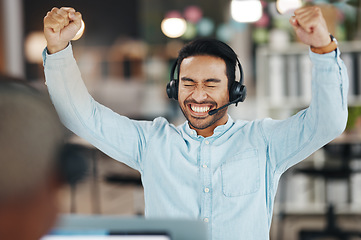 Image showing Asian man, call center and celebration for winning, bonus or discount sale on laptop in telemarketing at office. Happy and excited male consultant agent in joy for win, victory or bonus on computer