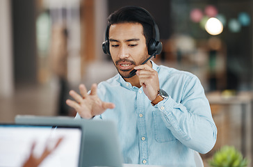 Image showing Asian man, call center and consulting with headphones on laptop in customer service or desktop support at office. Male consultant agent talking with headset on PC for telemarketing or online advice