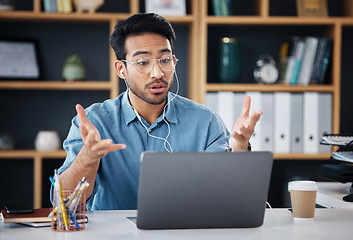 Image showing Asian man, laptop and consulting in video call for communication with earphones at office desk. Male employee talking or explaining in webinar, virtual meeting or networking on computer at workplace