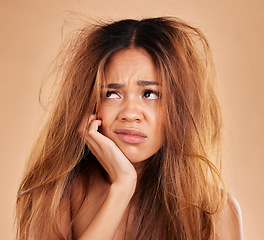 Image showing Sad face, hair loss and woman in studio isolated on a brown background for thinking. Idea, keratin damage or angry female model with haircare, messy hairstyle or split ends after salon treatment fail