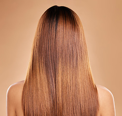 Image showing Haircare, beauty and back of woman with straight hair in studio isolated on brown background. Balayage, wellness and female model with salon treatment for growth, keratin texture or healthy hairstyle