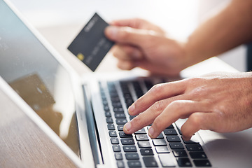 Image showing Hands, laptop and credit card for ecommerce, online shopping or electronic purchase on wooden desk. Hand of shopper working on computer keyboard for internet banking, app or wireless transaction