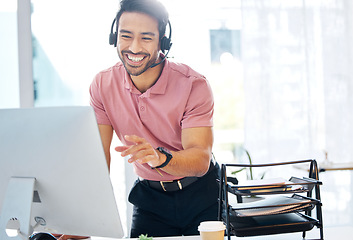 Image showing Asian man, call center and consulting with headphones on computer for customer service or desktop support at office. Happy male consultant agent talking with headset on PC for telemarketing or advice