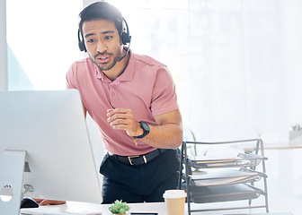 Image showing Asian man, call center and consulting with headphones on computer for customer service or desktop support at office. Male consultant agent talking with headset on PC for online telemarketing advice