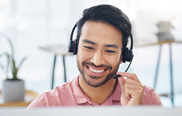 Image showing Asian man, call center and smile with headset mic on computer for consulting, customer service or support at office. Happy male consultant with headphones by PC for telemarketing or online advice