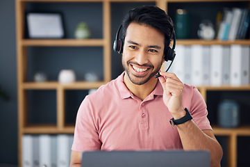 Image showing Asian man, call center and headset on laptop with smile for consulting, customer service or support at office. Happy male consultant with headphones by computer for telemarketing or online advice