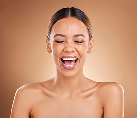 Image showing Beauty, face and a woman laughing in studio for skincare with dermatology, cosmetics or makeup. Happy aesthetic female model on a brown background for self care, skin glow and facial wellness