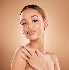 Image showing Beauty, portrait and a woman face with skin care glow and shine in studio on a brown background. Aesthetic female model hand for spa facial, natural dermatology cosmetics and wellness results